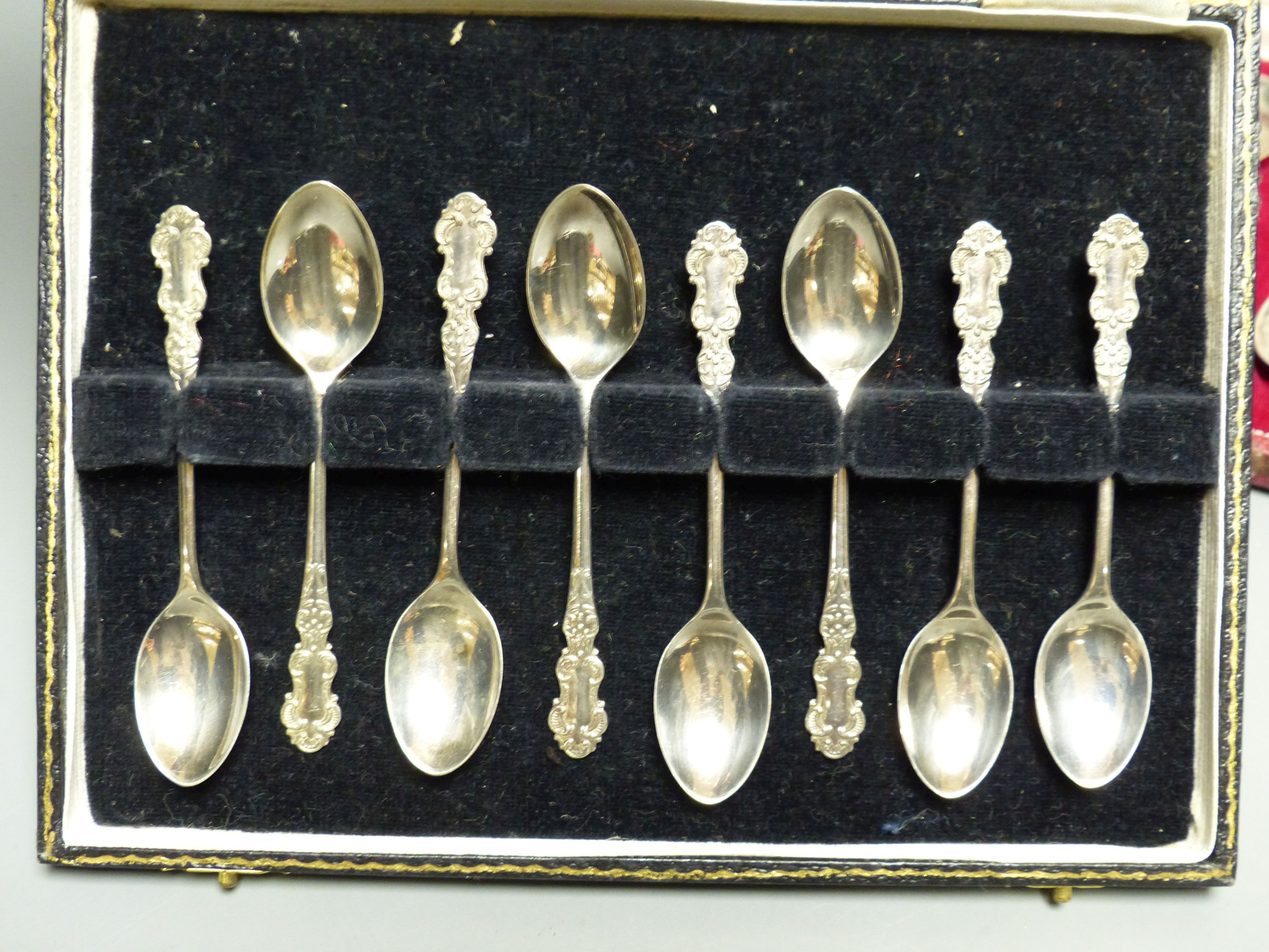 A modern case set of six silver preserve spoons, Sheffield, 1972 and a similar cased set of eight silver coffee spoons.